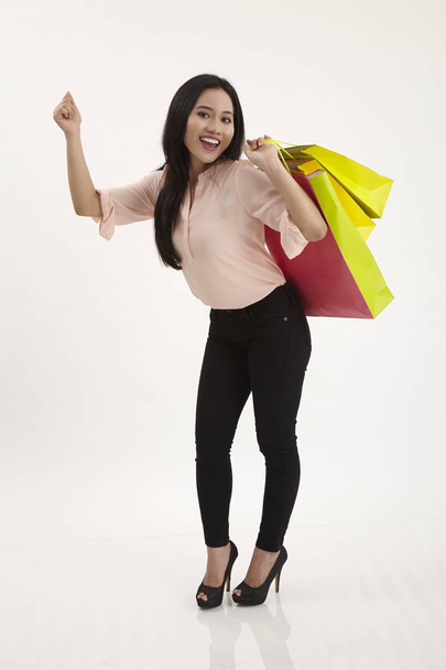 woman with shopping bags on a white background - Foto, afbeelding