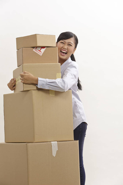 asian woman with stack of boxes on the white background - Foto, afbeelding