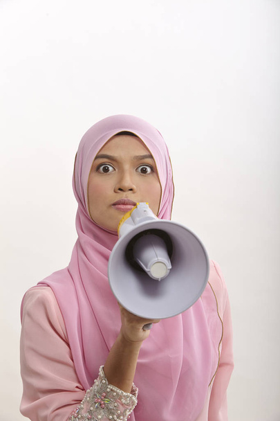 malay woman speaking into a megaphone making a public announcement isolated on white - Foto, Imagem
