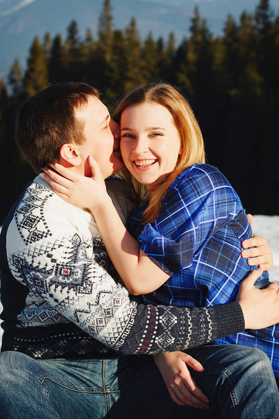 Beautiful young couple over amazingly snowy mountains - Photo, Image