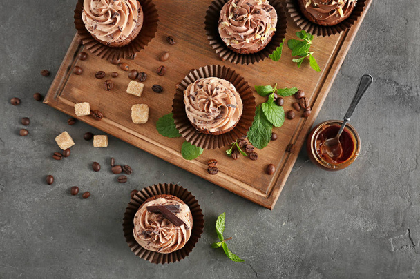 Composition with tasty chocolate cupcakes on grey background - Фото, зображення