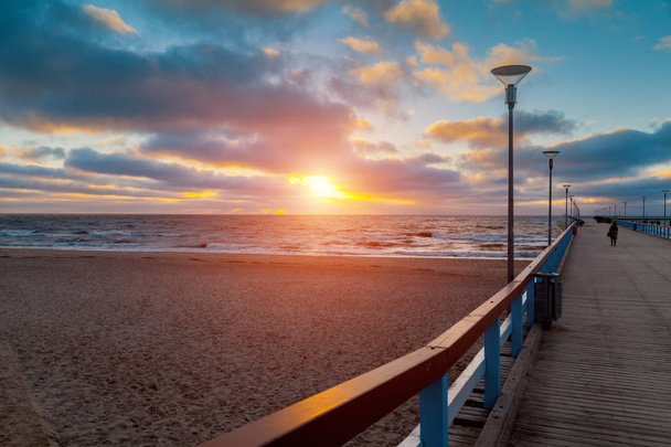 View of wooden pier over sea. Palanga city at sunset in autumn, Lithuania - Photo, Image