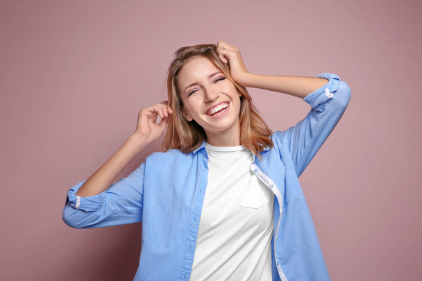 Smiling woman in casual clothes on color background - Φωτογραφία, εικόνα