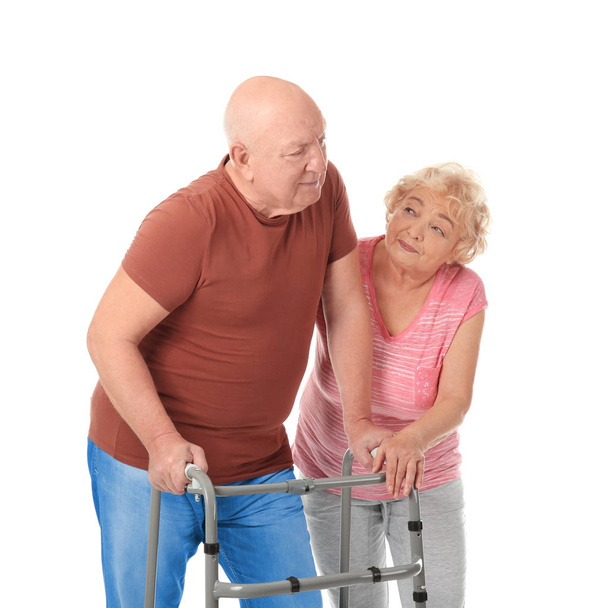 Elderly couple with walking frame on white background - Foto, afbeelding