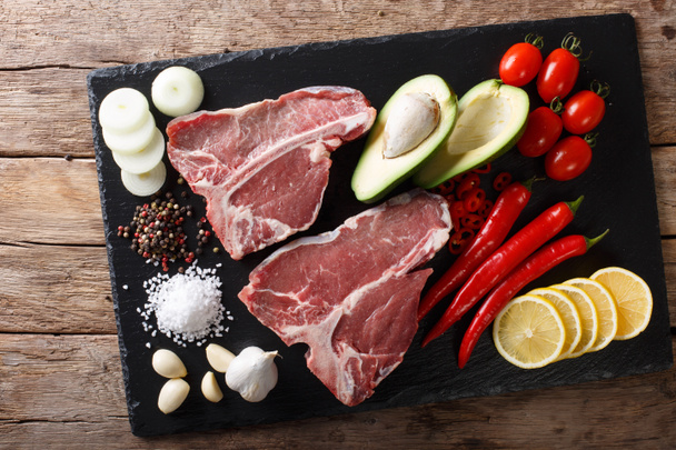 Organic raw t-bone beef steak with ingredients close-up. horizon - Фото, изображение