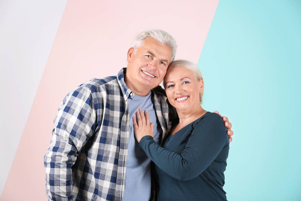 Mature couple against color background - Foto, afbeelding