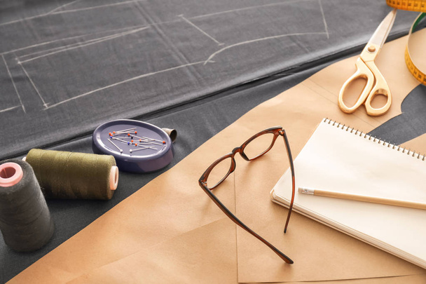 Notebook with sewing accessories on table - Φωτογραφία, εικόνα