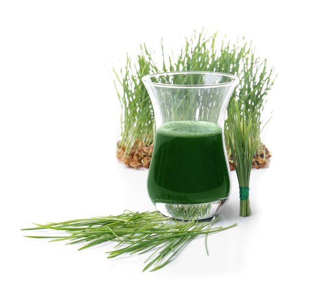 Shot of healthy juice and sprouted wheat grass on white background - Foto, immagini