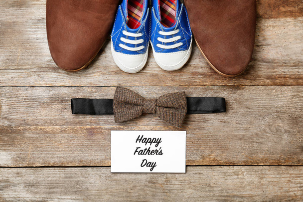 Bow tie, big and small shoes on wooden background. Father's day composition - Φωτογραφία, εικόνα