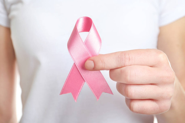 Woman holding pink ribbon. Breast cancer awareness concept - Fotografie, Obrázek