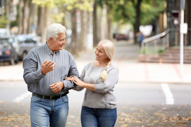 Mature couple walking together outdoors - Photo, Image