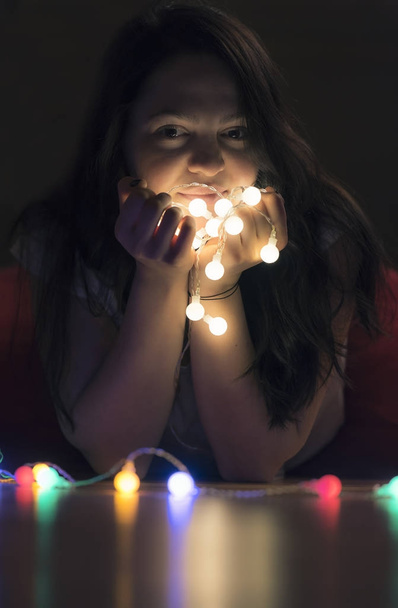 Beautiful woman with lit string lights - Foto, Imagem