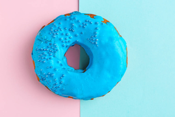 Delicious blue donut on color background, top view - Zdjęcie, obraz