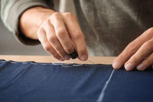 Young tailor working with textile, closeup - Foto, Imagen