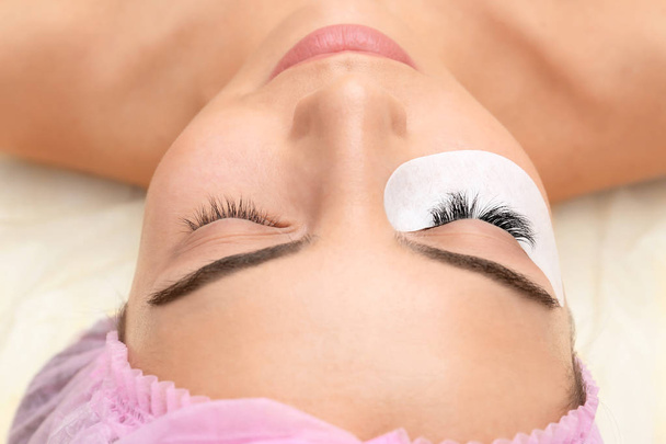 Young woman undergoing eyelash extensions procedure, closeup - Foto, immagini