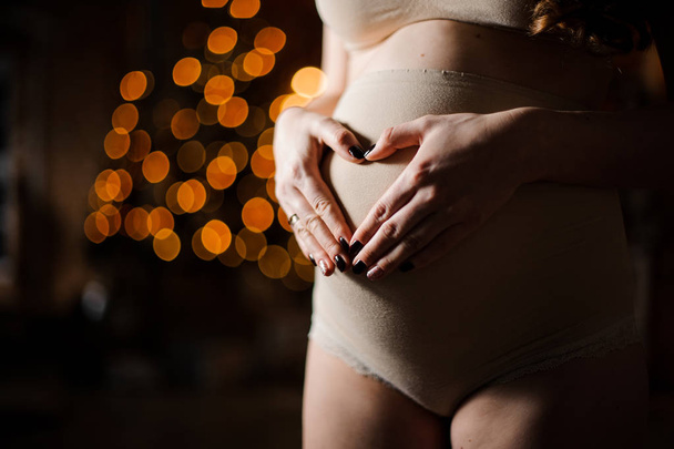 Woman putting hands on her pregnant belly - Photo, Image