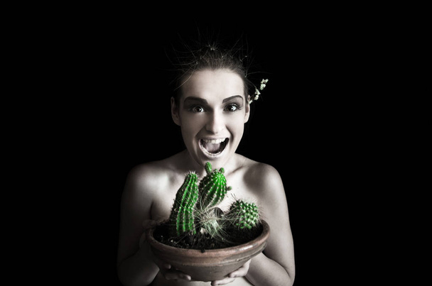 woman wants to eat a cactus - Fotoğraf, Görsel