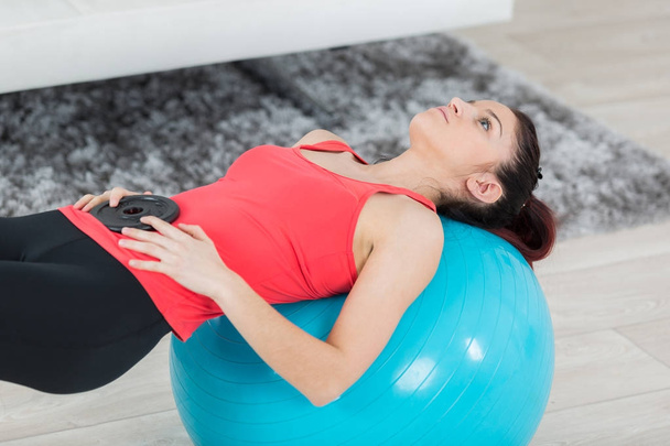 young woman doing exercises on the ball - Photo, Image