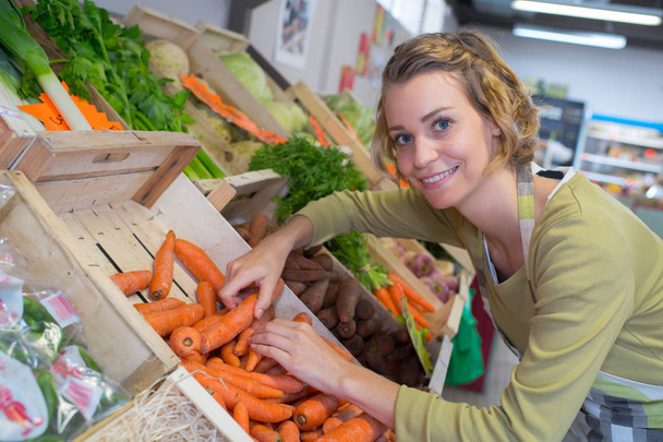 smiling female seller in vegetables market - Foto, immagini
