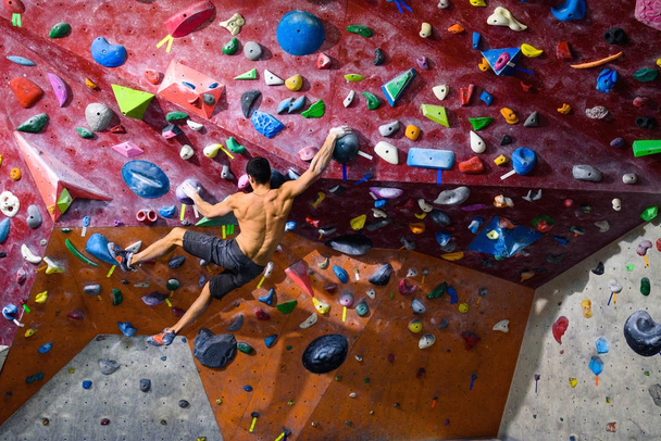 Workout exercise. Sporty male training indoor, climbing gym.  - 写真・画像