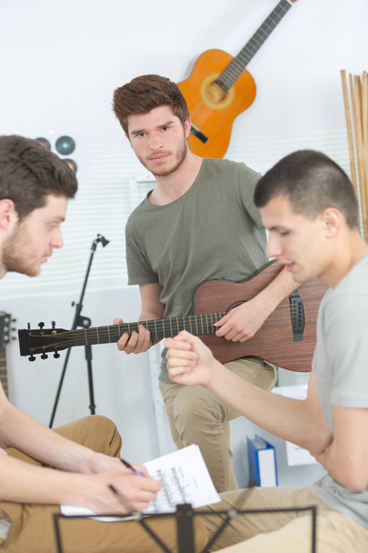 three friends playing instruments at home - Photo, image