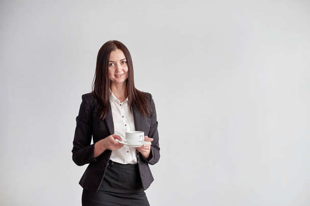 office worker offering you a cup of coffee or tea over white background - Valokuva, kuva