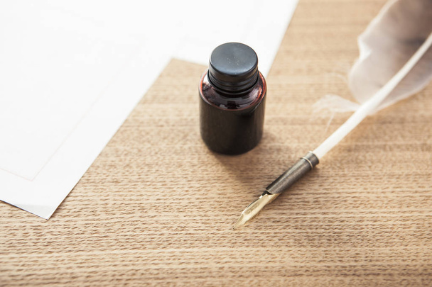 vintage pen with ink, nib(pen tip) on the wood desk. - Photo, Image