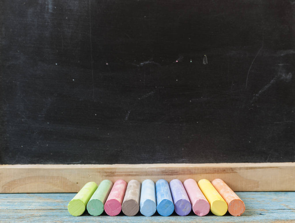School supplies on blackboard  and empty surface. - Fotografie, Obrázek