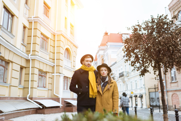 beautiful young couple in autumn outfit on city street - Photo, Image