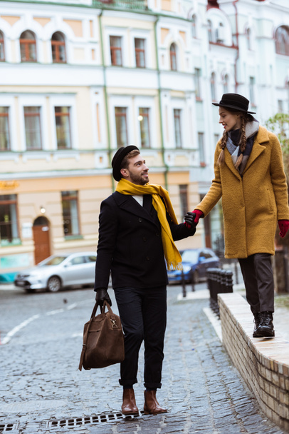junges attraktives Paar hält Händchen und geht auf der Straße - Foto, Bild