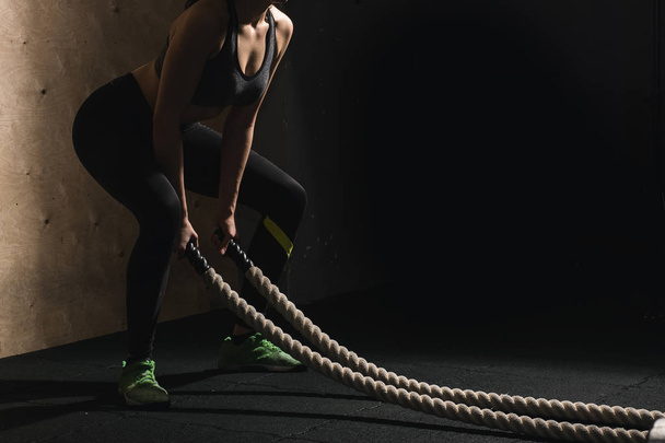 battling ropes girl at gym workout exercise fitted body - Valokuva, kuva