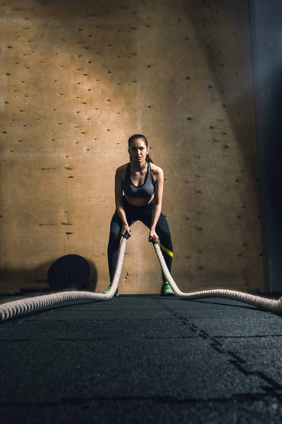 woman working out with battle ropes - Valokuva, kuva