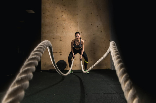 woman working out with battle ropes - Photo, image