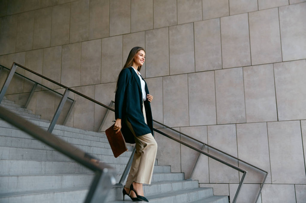 Portrait Of Stylish Business Woman With Handbag In Hand Outdoors - Foto, afbeelding