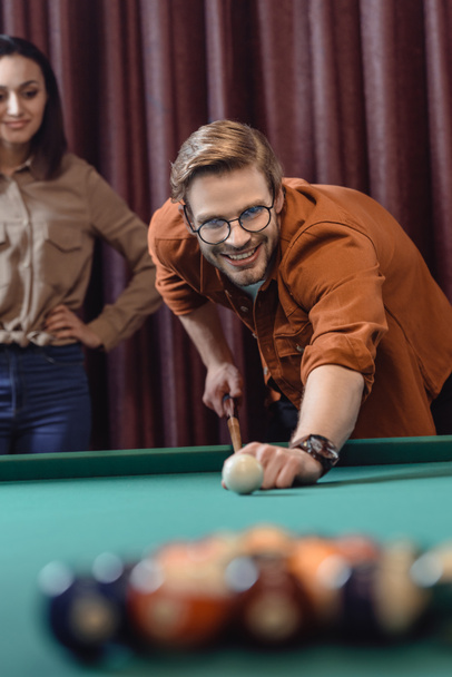 handsome man playing in pool at bar - Photo, Image