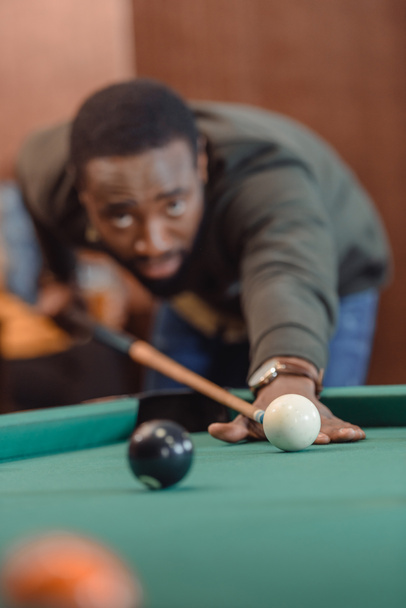 african american man playing in pool at bar - Фото, зображення