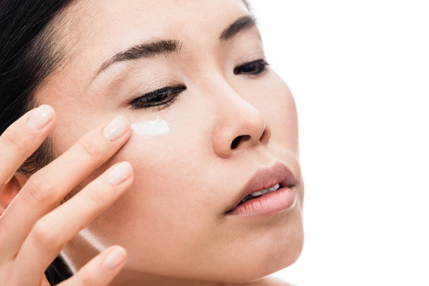 Young woman applying anti-wrinkles eye moisturizer - Фото, изображение