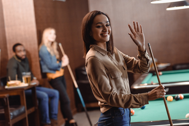 young attractive girl waving hand at pool bar - 写真・画像