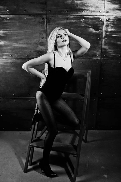 Elegante blonde girl wear on combi dress posed on chair against  - Fotoğraf, Görsel