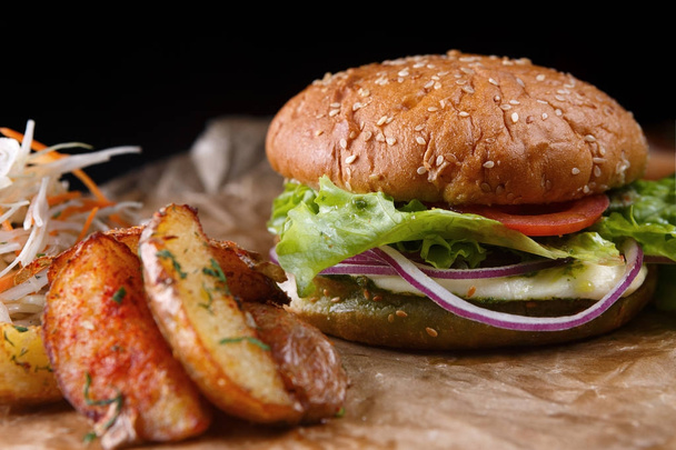Burger with cheese, vegetables and potatoes - 写真・画像