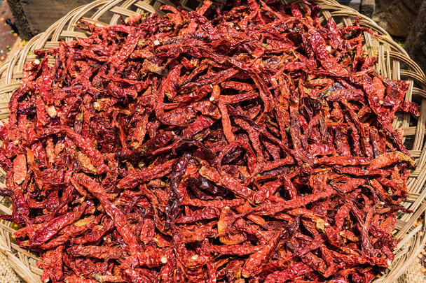 Dried Chili Peppers in basket on the wooden table background - 写真・画像