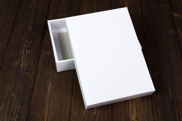 Empty white gift box or tray for mock up on dark wooden table wi - Foto, Imagem