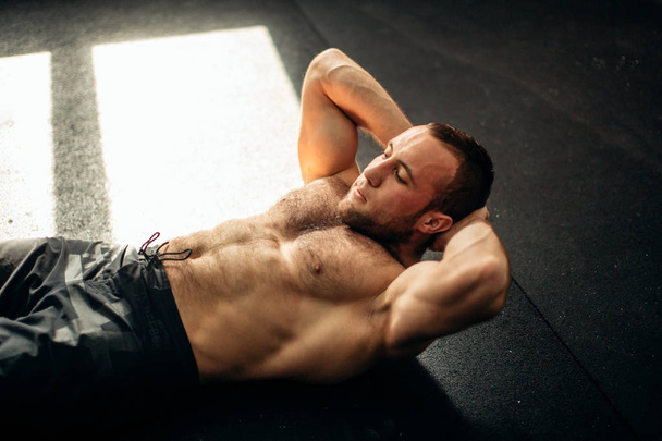 Muscular man exercising doing sit up exercise - Φωτογραφία, εικόνα