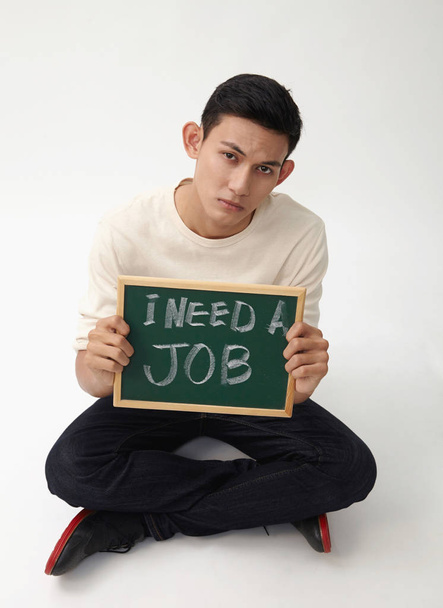 malay teenage holding a message that he need job - Foto, imagen