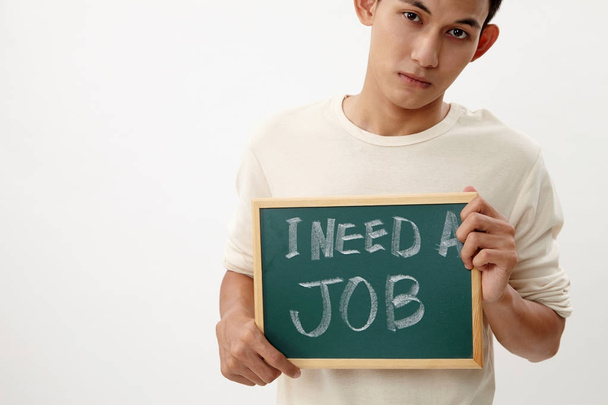 malay teenage holding a message that he need job - Foto, afbeelding