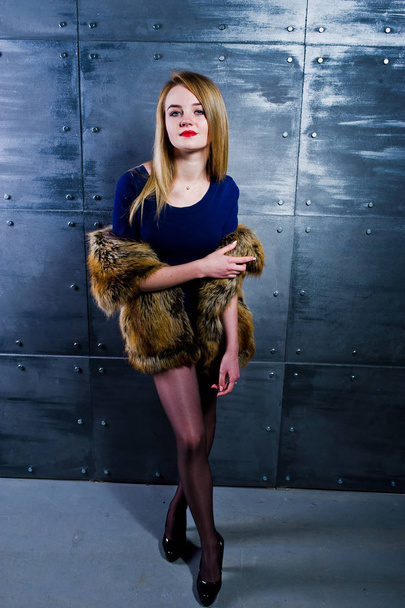 Elegante blonde girl wear on fur coat and combi dress against st - Fotografie, Obrázek