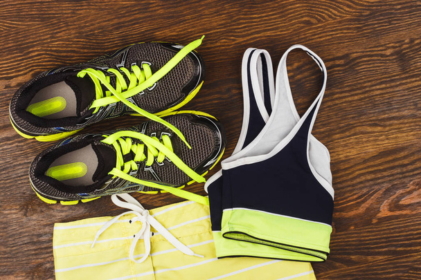 Green sneakers, shorts and sport bra - Foto, afbeelding