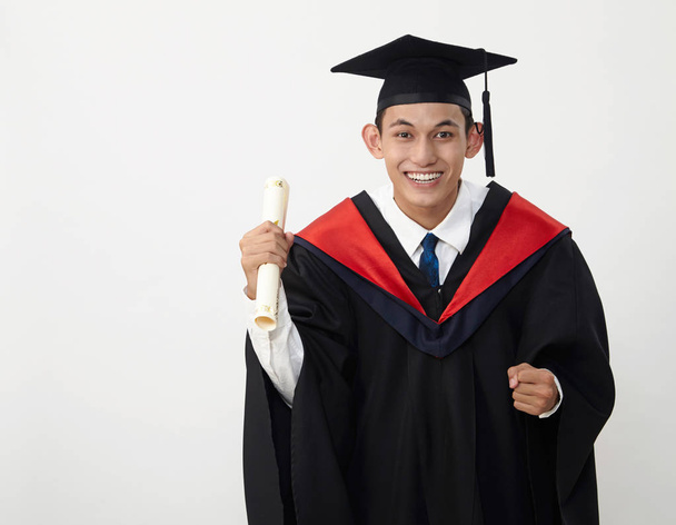 young malay teenage graduated student wear rope holding certificate  - Foto, Imagem