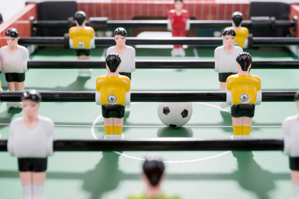 Table football game with white and yellow players team in table soccer or football kicker game - Fotoğraf, Görsel