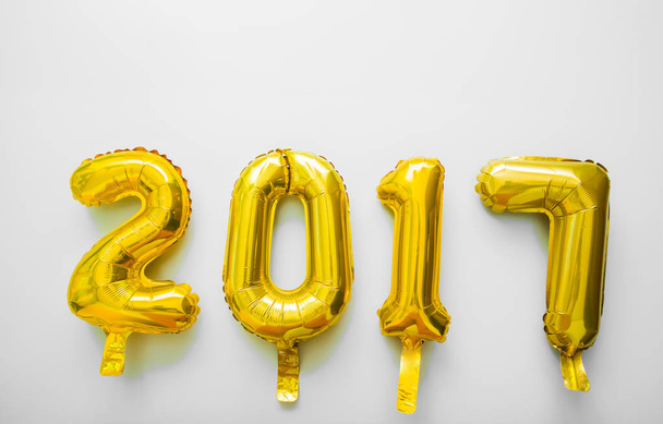 Golden toy balloons isolated on white background. Happy New Year 2017. - Φωτογραφία, εικόνα